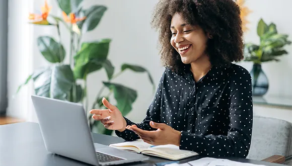 woman-smiling-working-on-her-computer